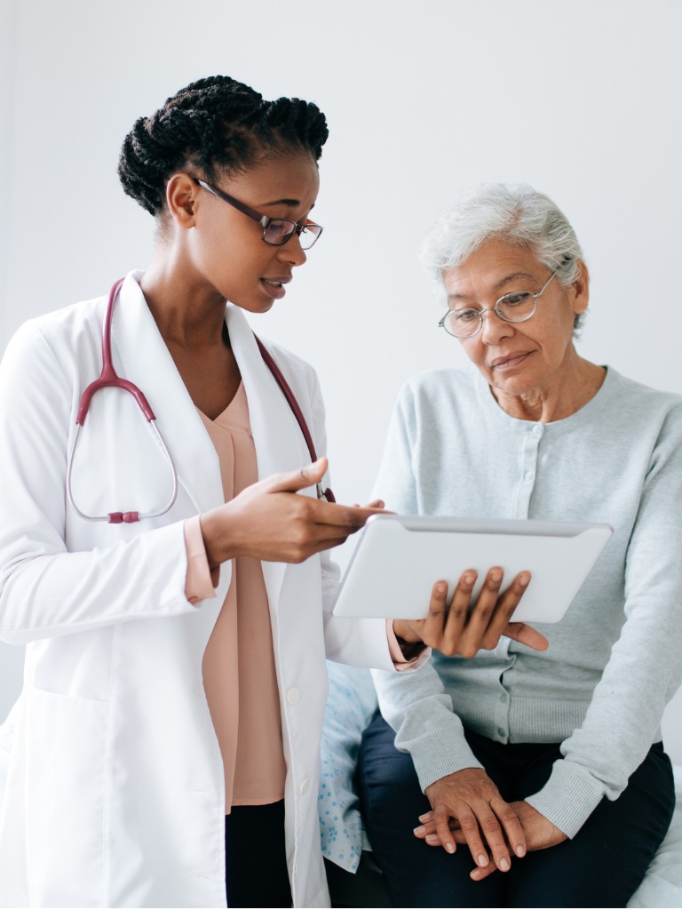 Black female dermatologist with patient